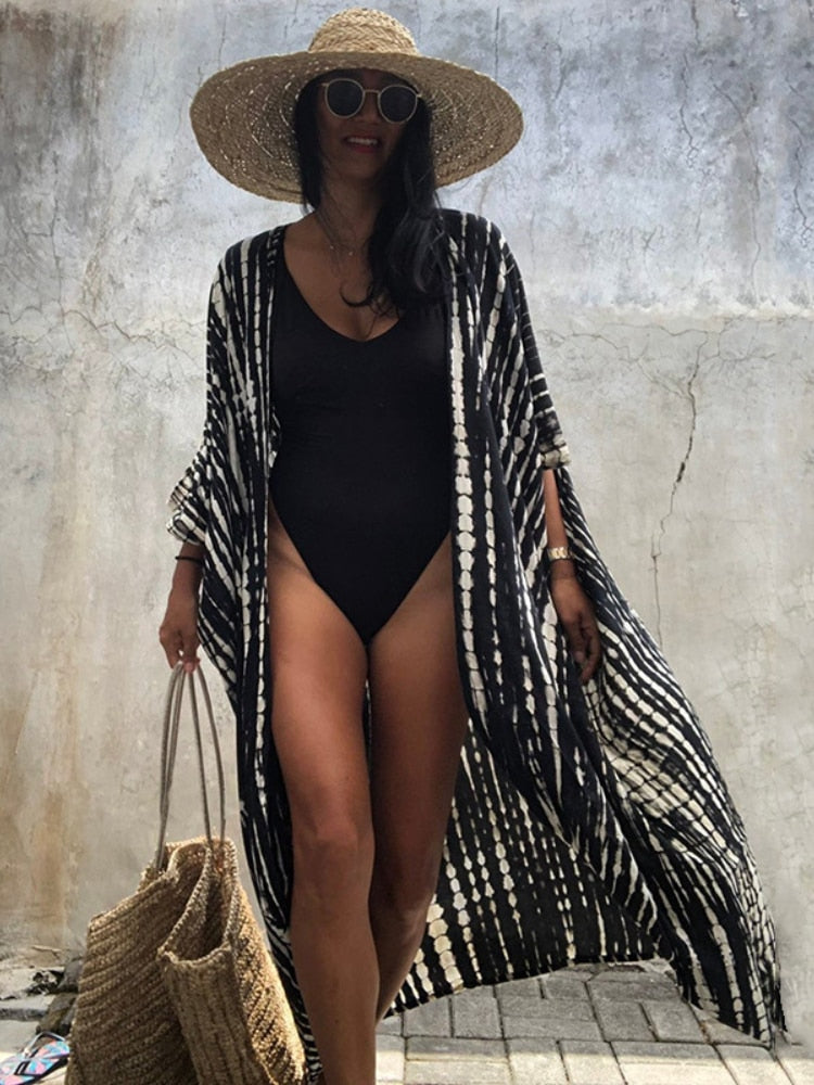 Get beach-ready in our Black Tie-Dye Kimono Swimsuit - the ultimate fusion of style and comfort for women in 2022. Embrace the latest trend in beachwear